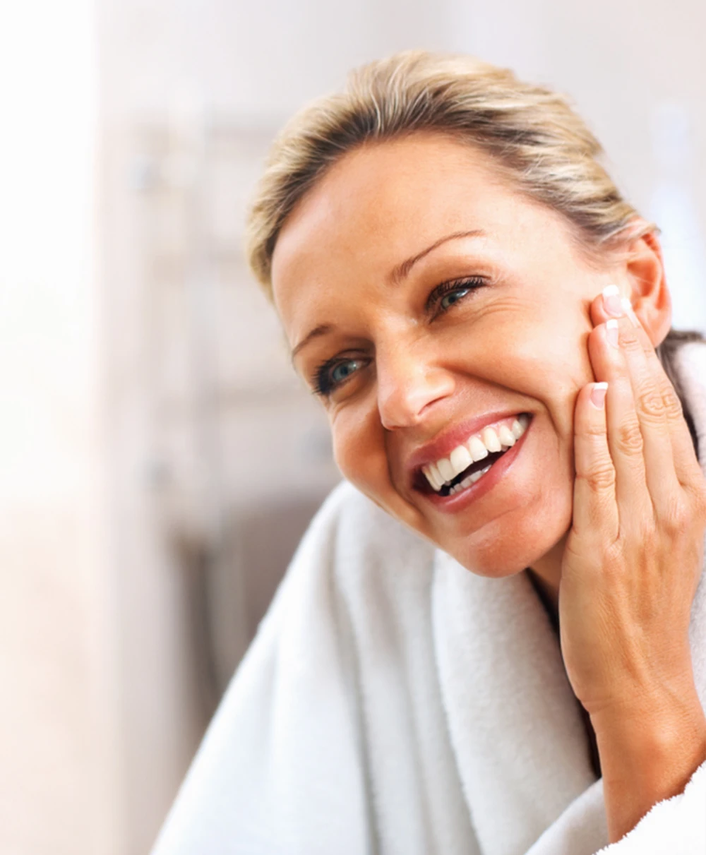 Middle Age Female Smiling at her Youthful Reflection in the Mirror