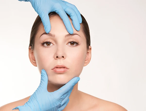 Facial Plastic Surgeon Evaluating a Young Female Patients Face for Facelift