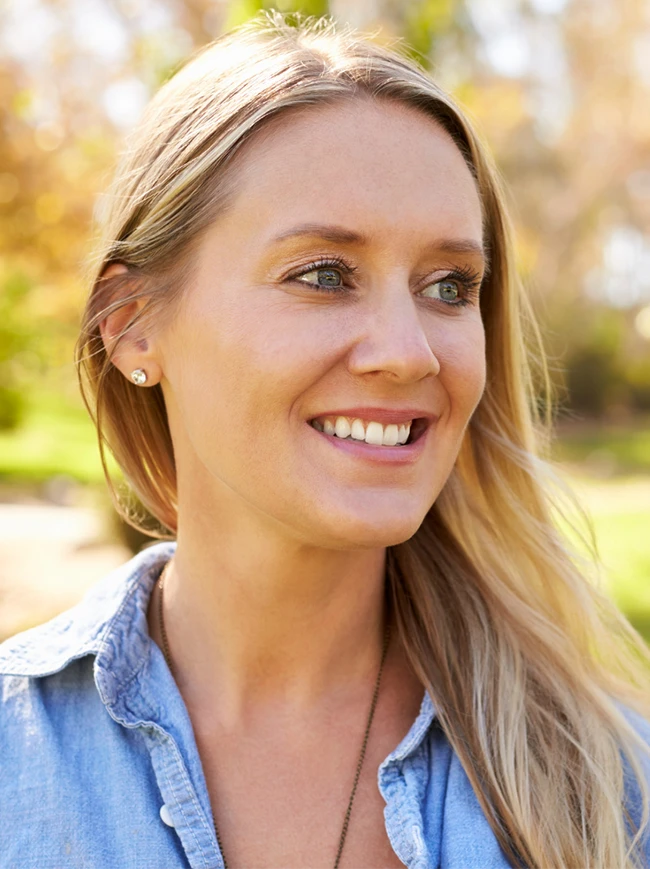 Blonde Female With Youthful Facial Features and No Signs of Aging Enjoying the Park