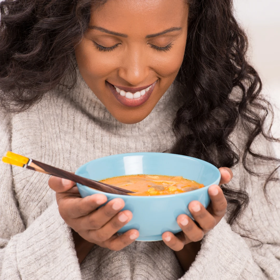 Woman Eating Healthy Soup During Facelift Recovery